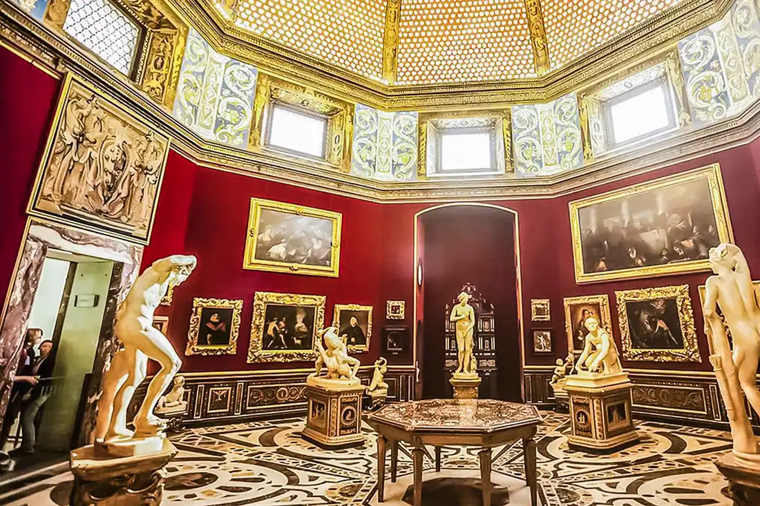 The octagonal Tribuna room with its shell dome and red walls in the Uffizi Gallery, the most famous of the art museums in Florence, Italy