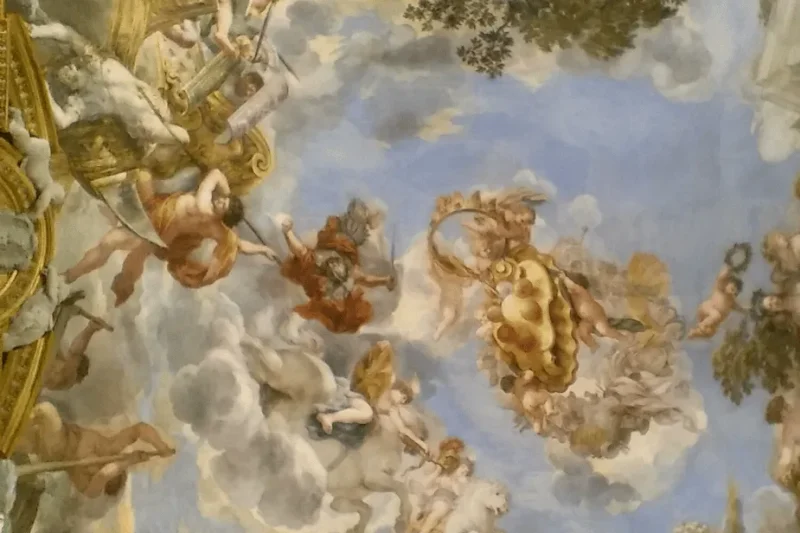 The frescoed ceiling of the Palatina Gallery at Pitti Palace, among the great art museums in Florence, Italy